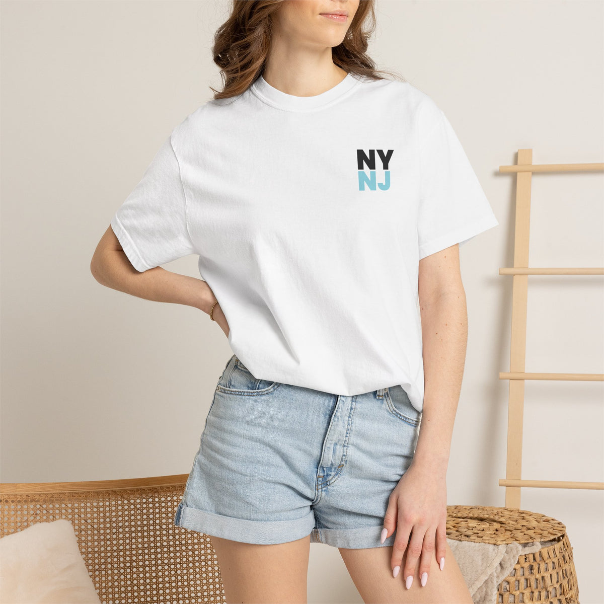 White relaxed-fit NY/NJ Statue graphic tee being worn by a model for women's pro soccer fan style.