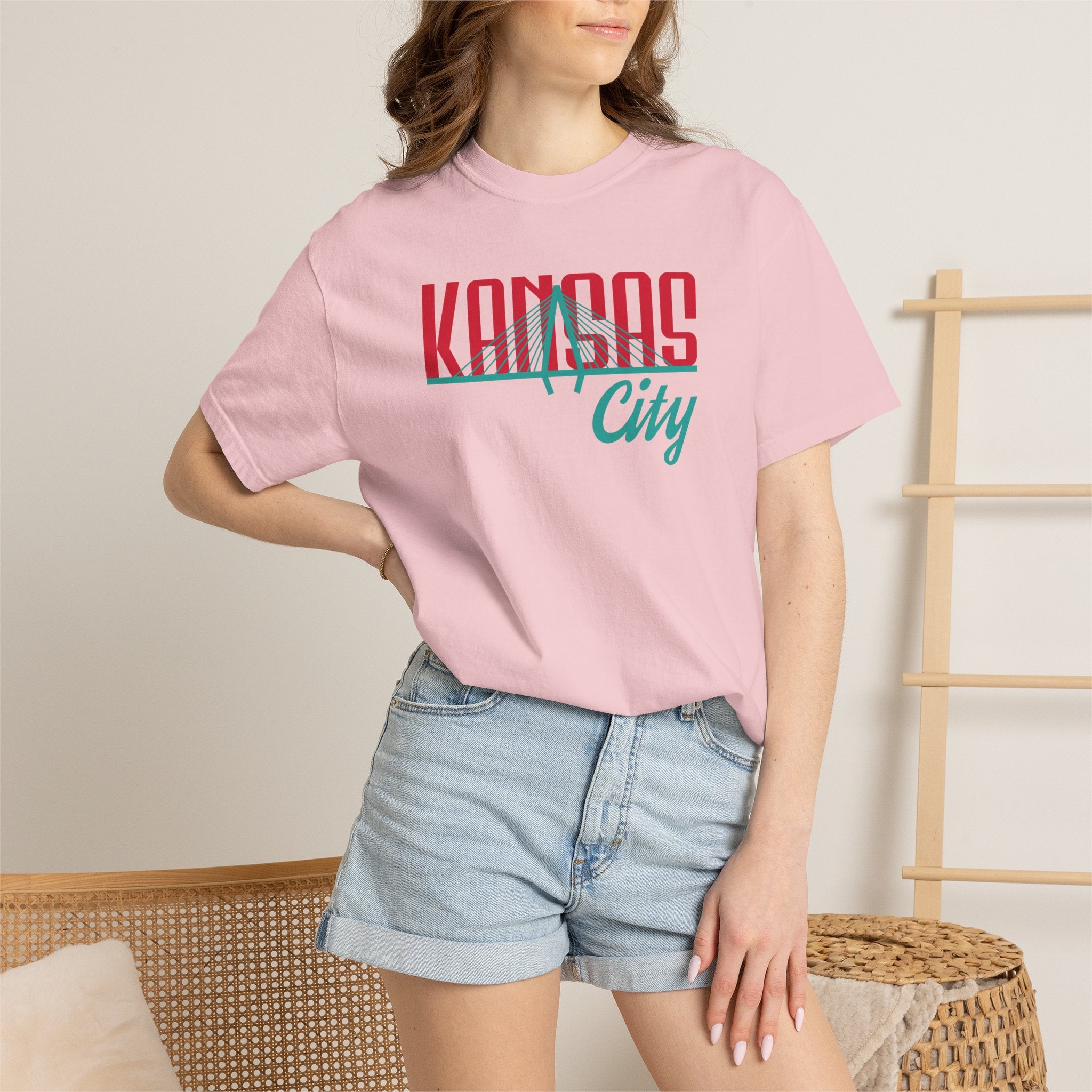 Blossom pink garment-dyed t-shirt front view featuring "Kansas City" with bridge graphic in red and teal retro script across the chest.