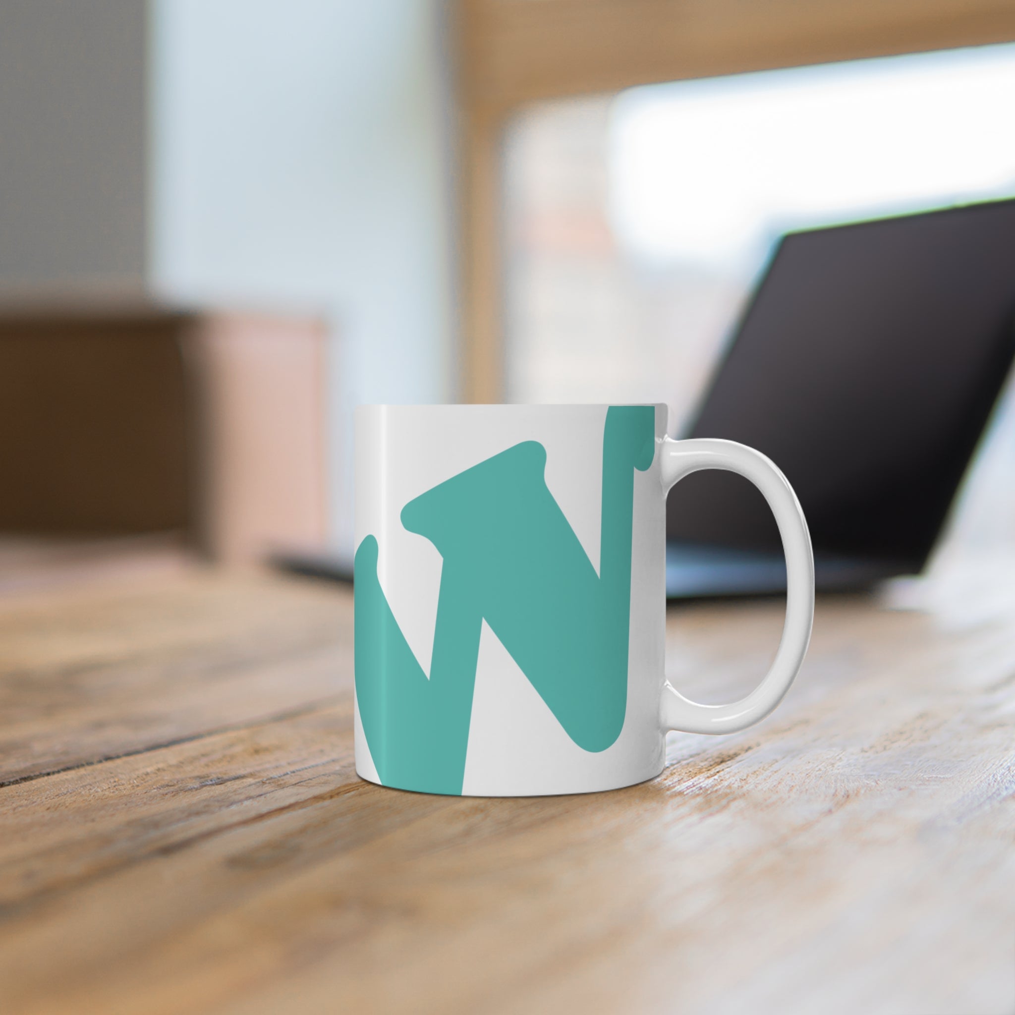 White ceramic coffee mug with teal W soccer club logo printed on the side from the WSC collection