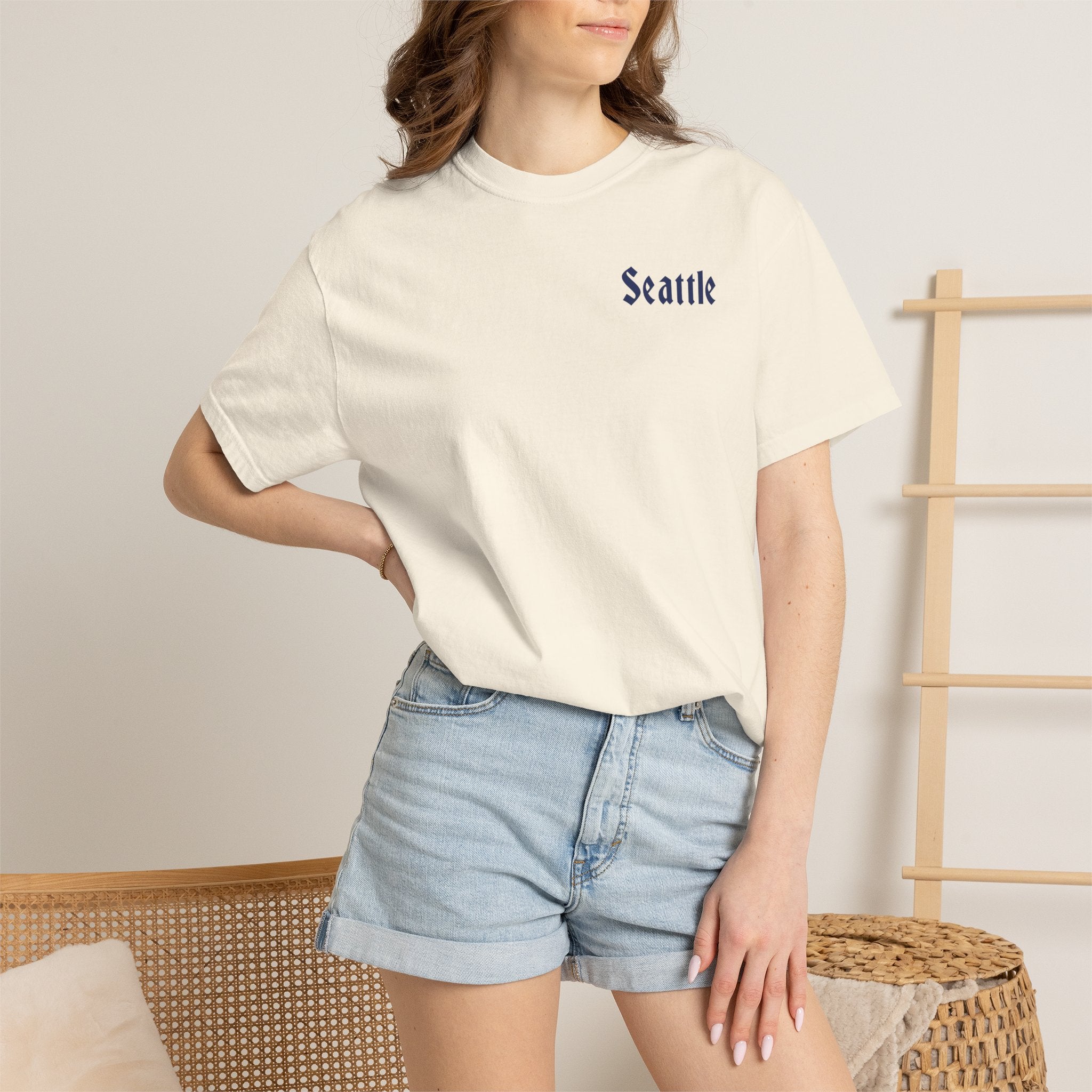 Ivory heavyweight garment-dyed t-shirt front view featuring a minimal "Seattle" script on the left chest.