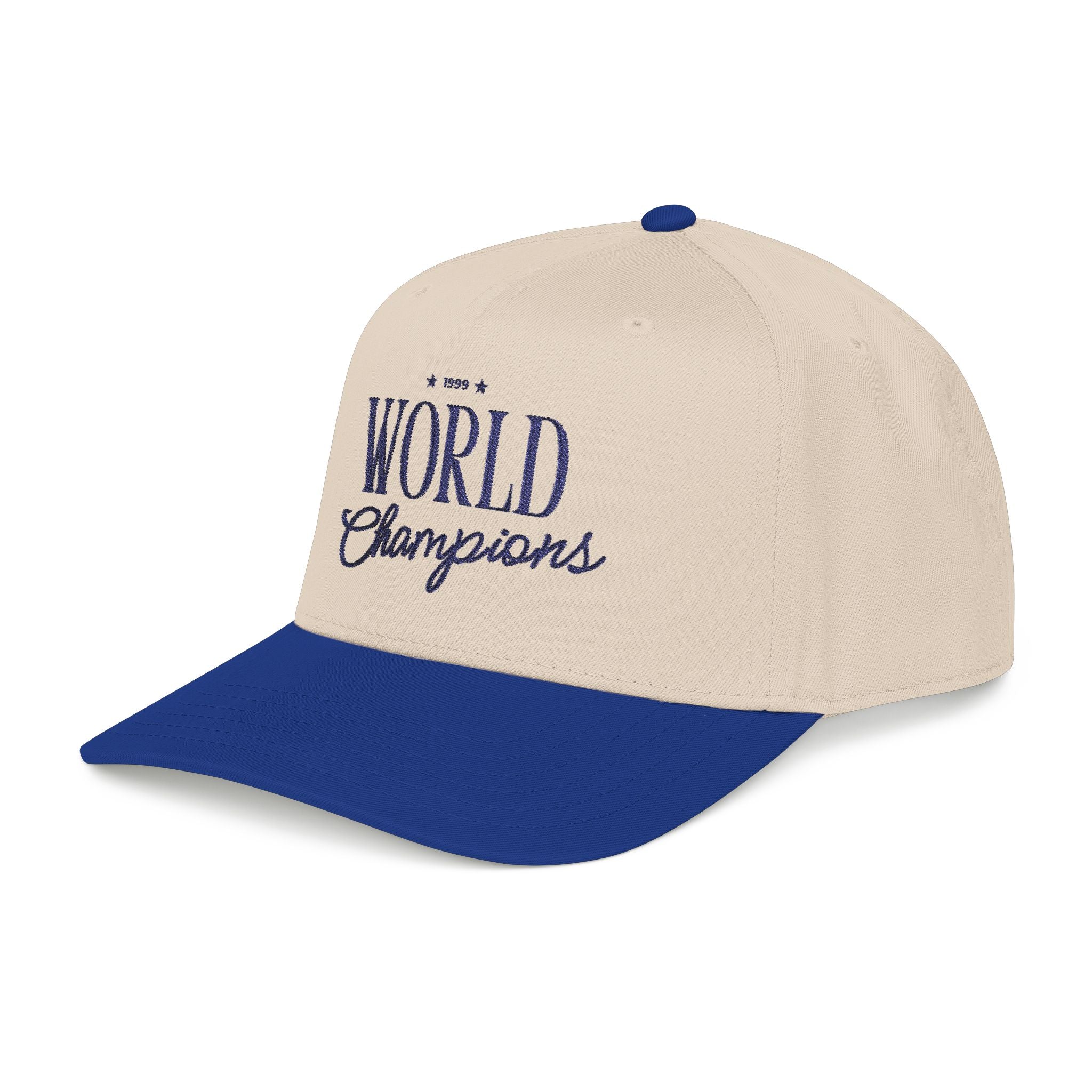 A two-tone baseball cap with an off-white crown and a royal blue brim, featuring '1999 World Champions' embroidered in blue on the front.