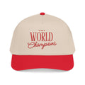 A beige and red baseball cap with '1999 World Champions' embroidered in red on the front, set against a plain white background.
