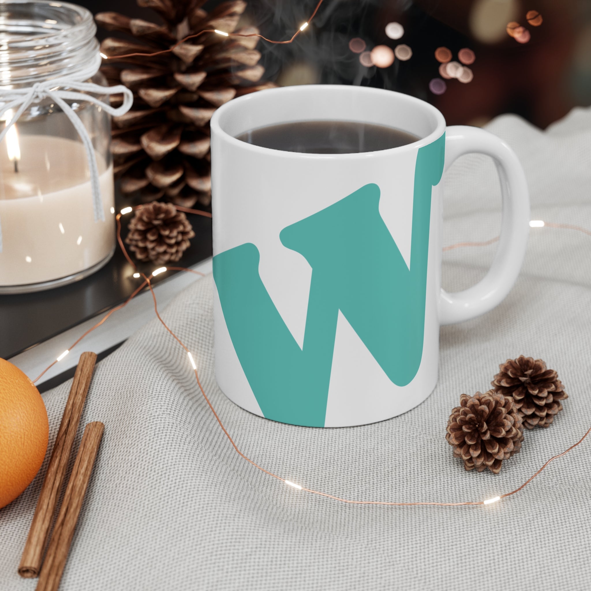 White ceramic coffee mug with teal W soccer club logo printed on the side from the WSC collection
