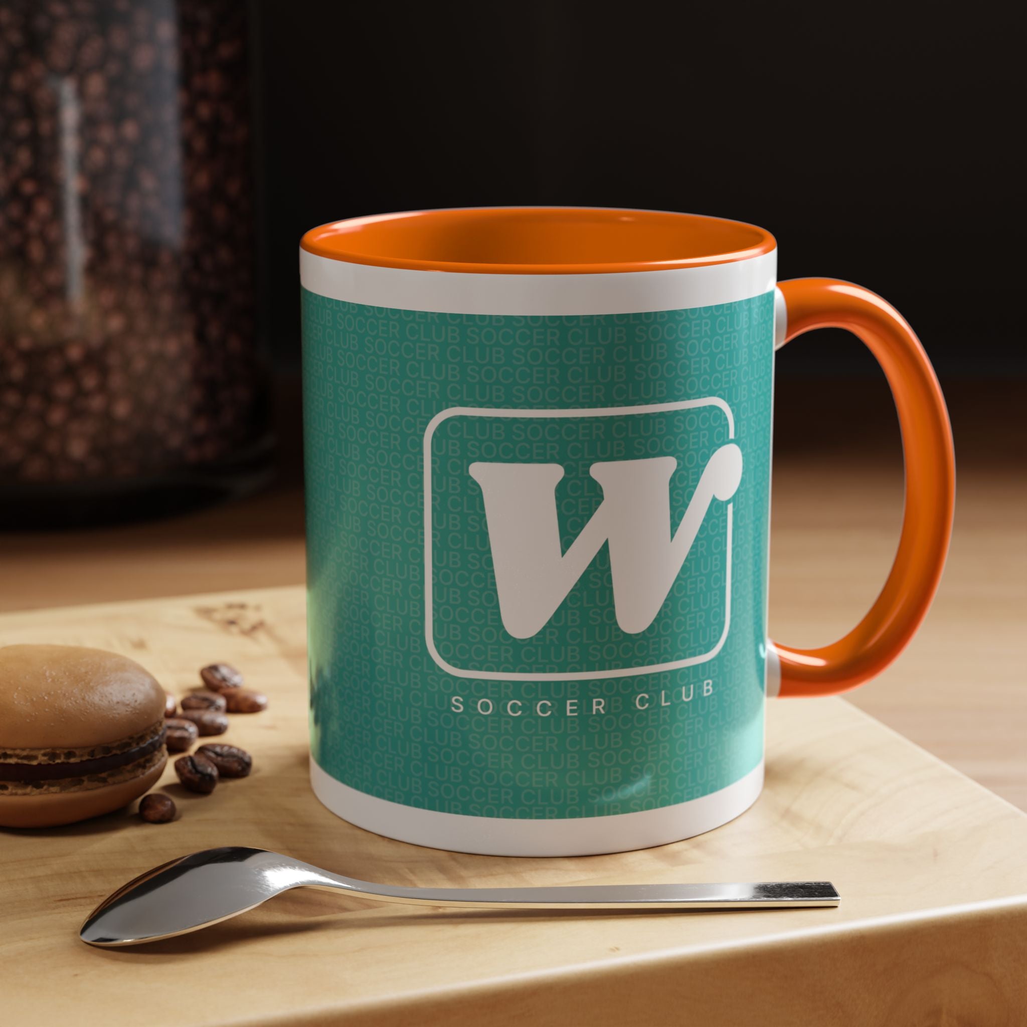 Orange W Soccer Club ceramic accent mug, with a teal wraparound soccer club design and the bold 'W' logo 