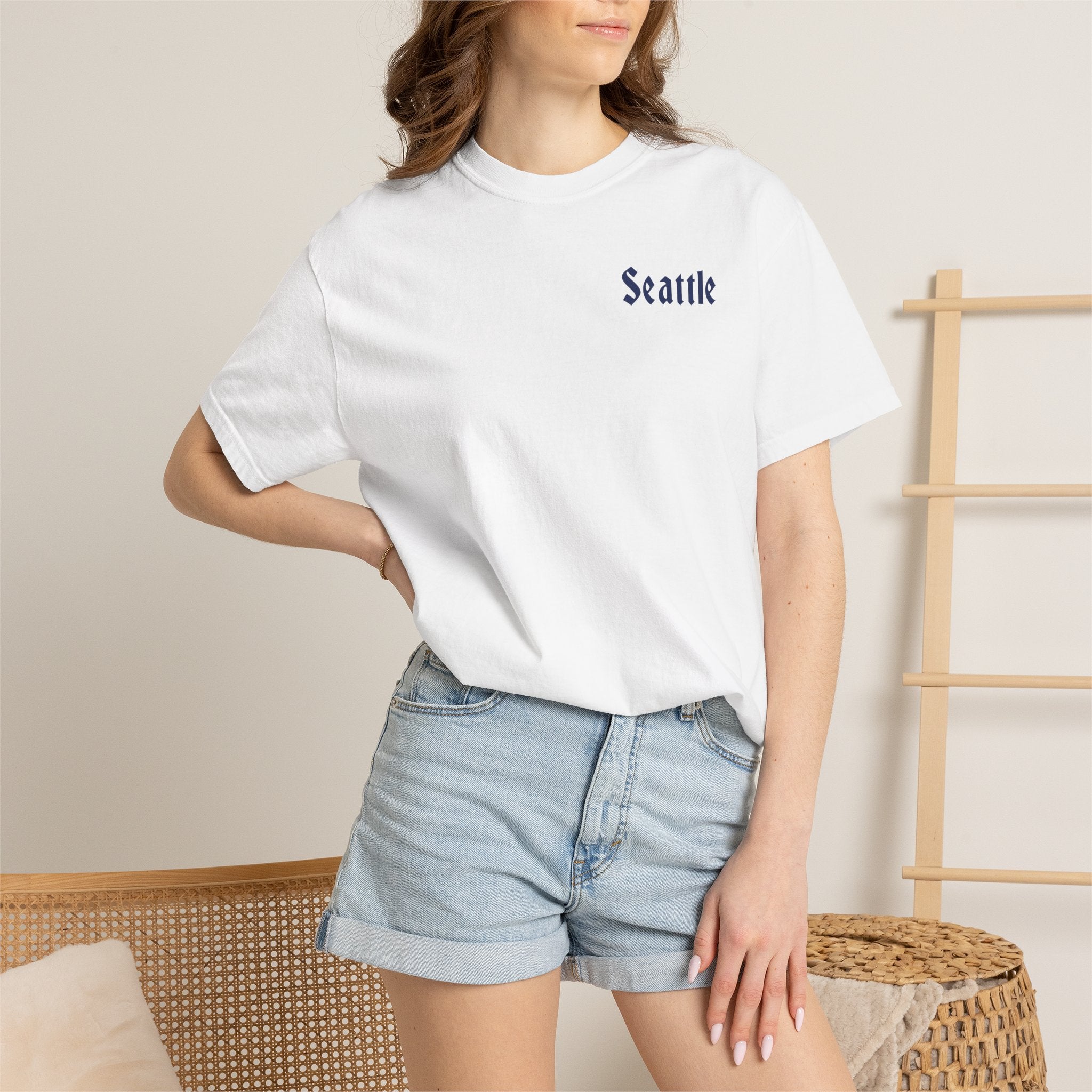 White heavyweight garment-dyed t-shirt front view featuring a minimal "Seattle" script on the left chest.