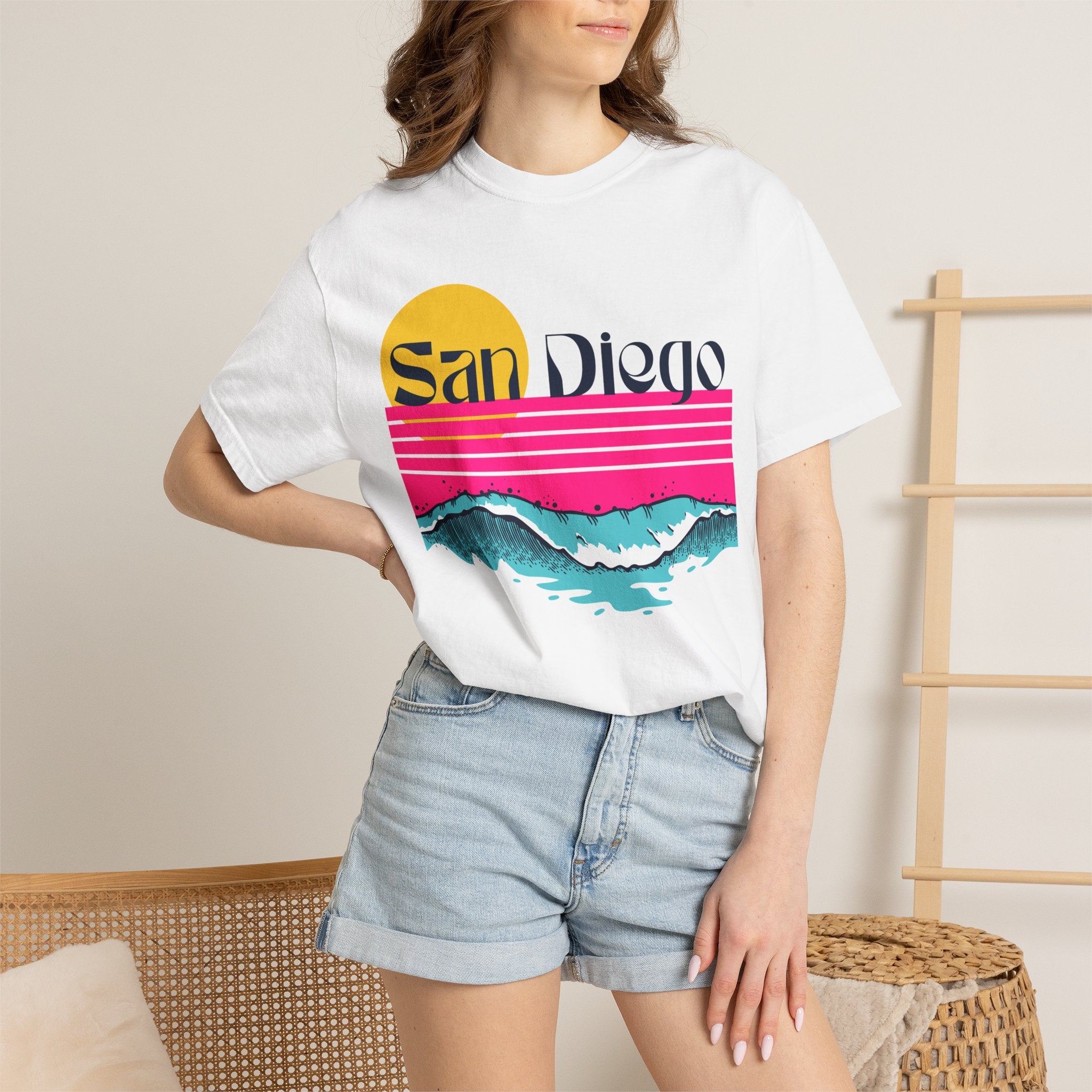 White short-sleeve crewneck t-shirt featuring a retro-style sunset and ocean waves graphic with the text 'San Diego' across the chest