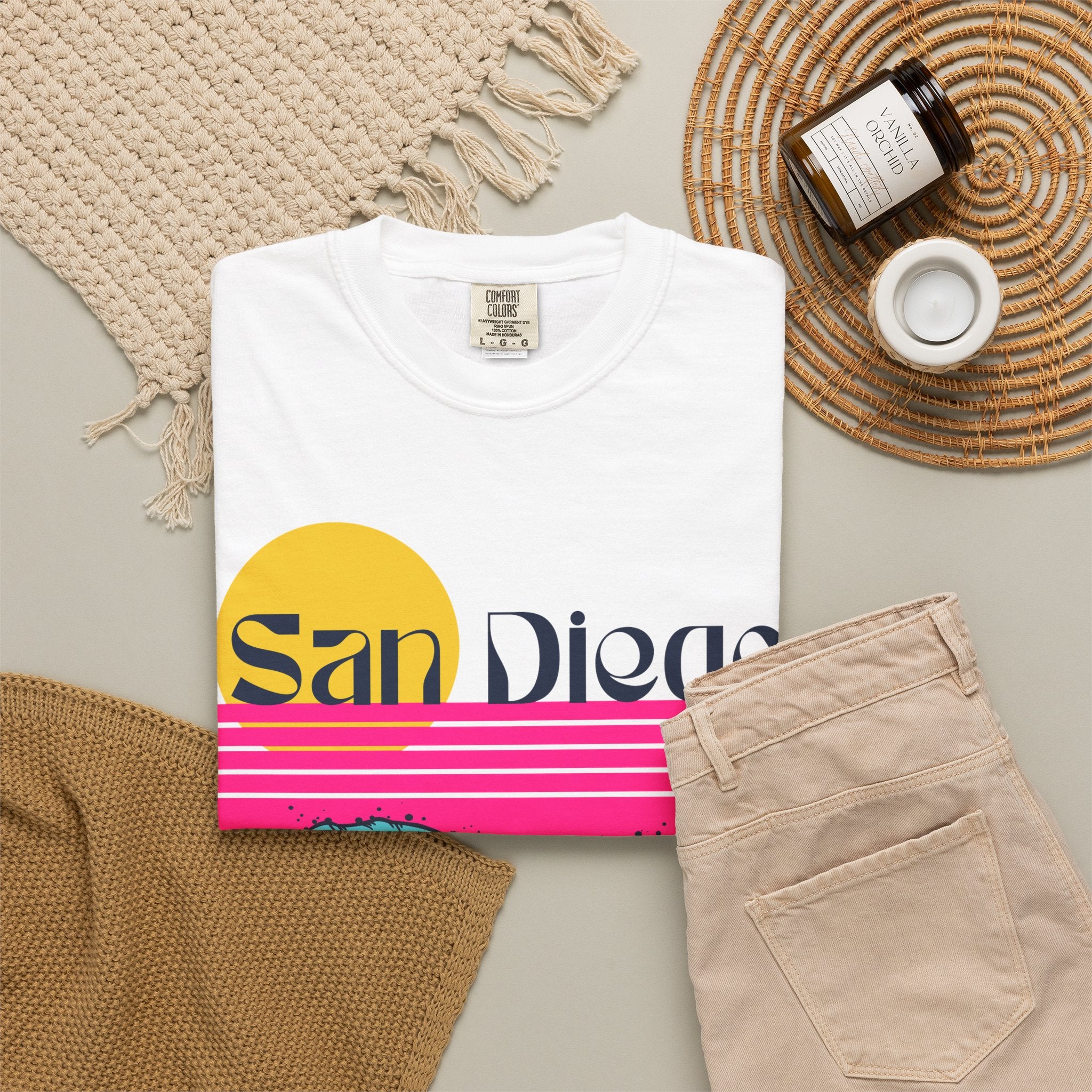 White short-sleeve crewneck t-shirt featuring a retro-style sunset and ocean waves graphic with the text 'San Diego' across the chest