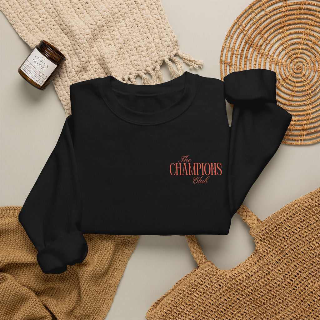 Black sweatshirt with The Champions Club pocket logo on the front