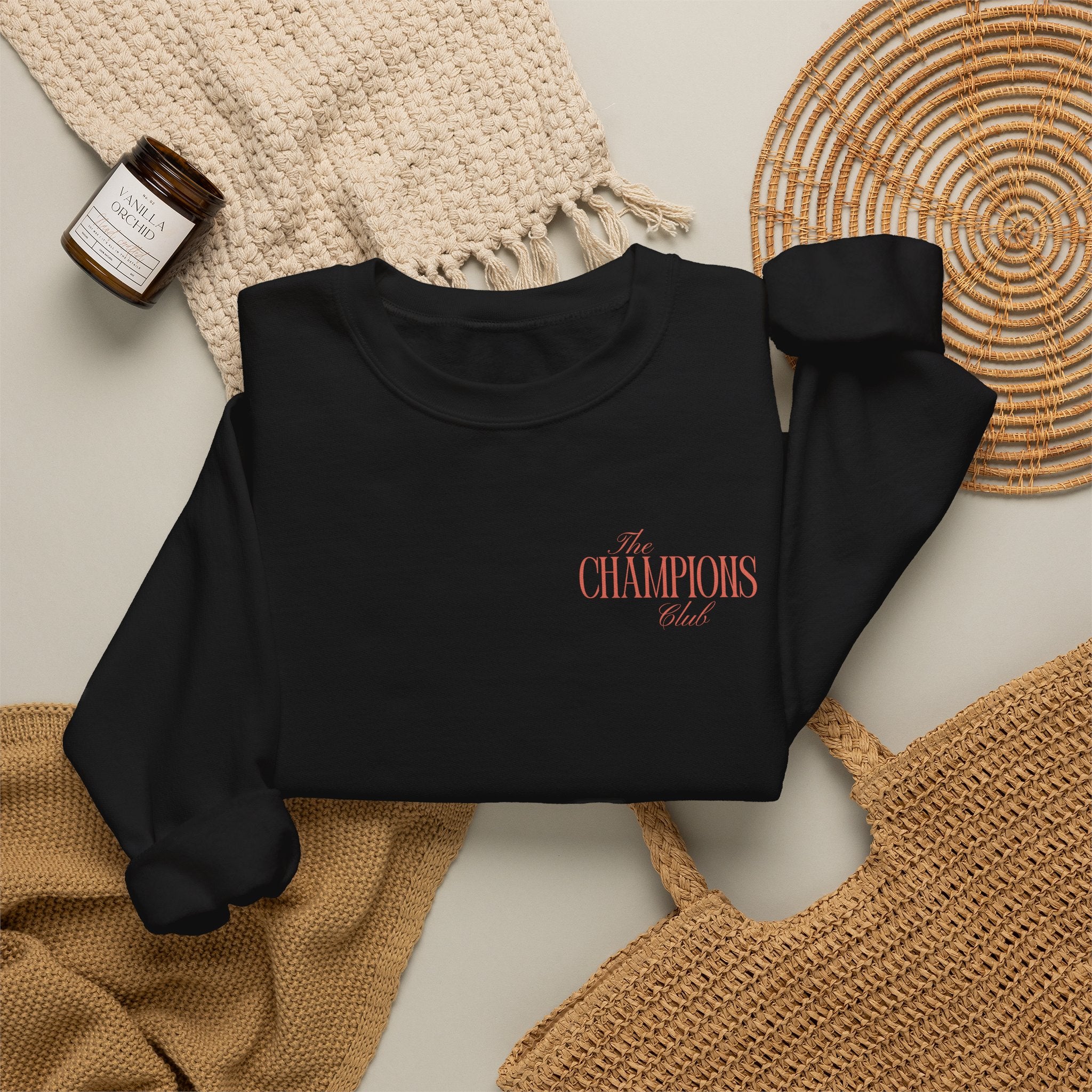 Black sweatshirt with The Champions Club pocket logo on the front