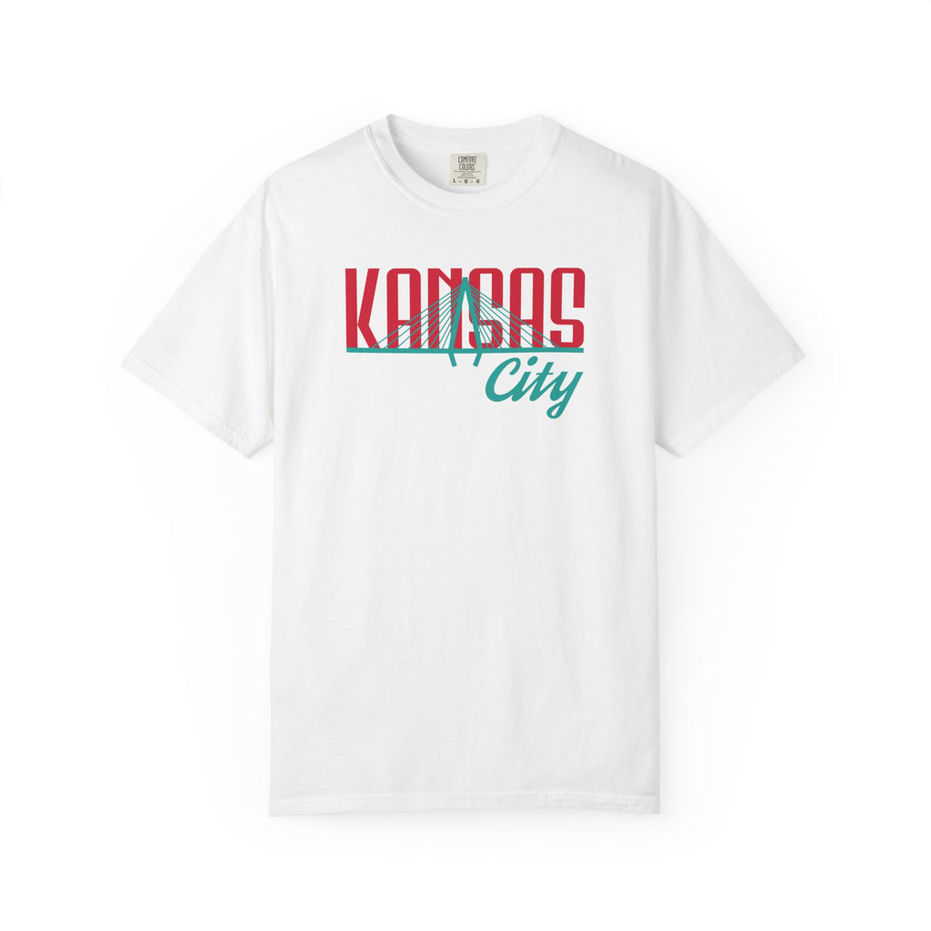 White garment-dyed t-shirt front view featuring "Kansas City" with bridge graphic in red and teal retro script across the chest.