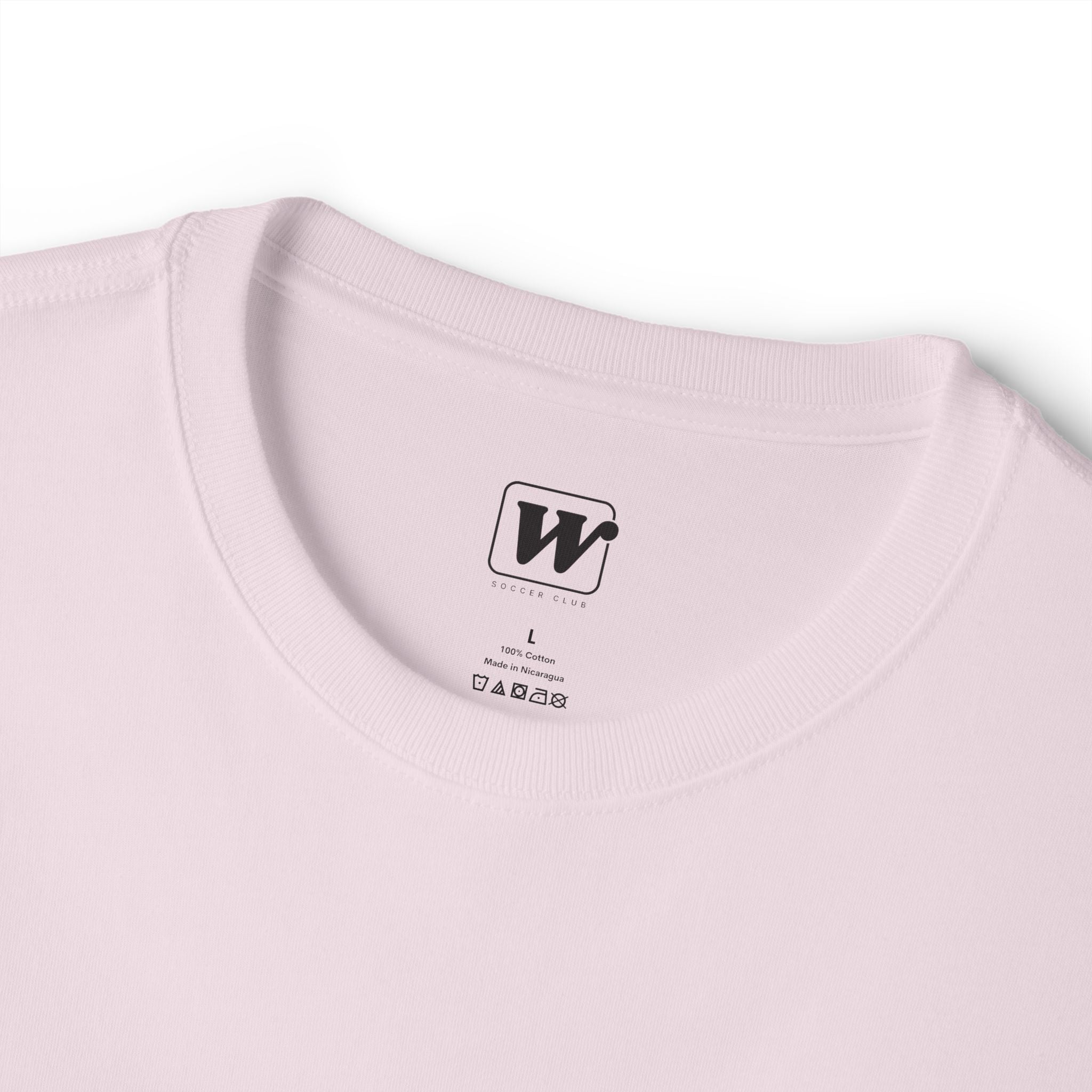 Soft Pink 'Elite Company Only' boxy t-shirt close-up with W Soccer Club logo on the inside tag