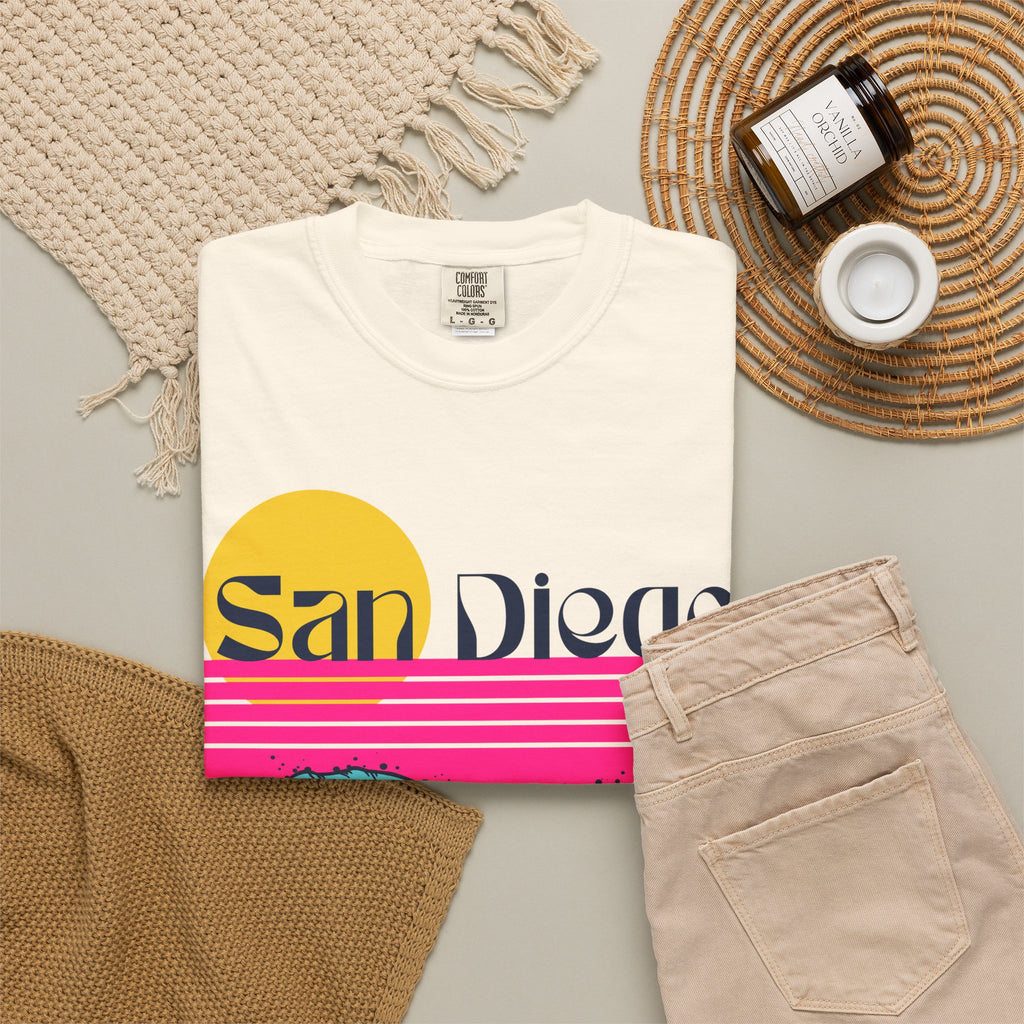 Ivory short-sleeve crewneck t-shirt featuring a retro-style sunset and ocean waves graphic with the text 'San Diego' across the chest