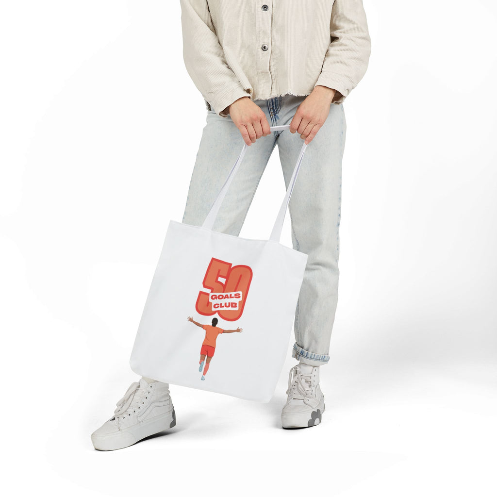 A white canvas tote bag with two shoulder straps, featuring a graphic print of a player running underneath a '50 GOALS CLUB' graphic