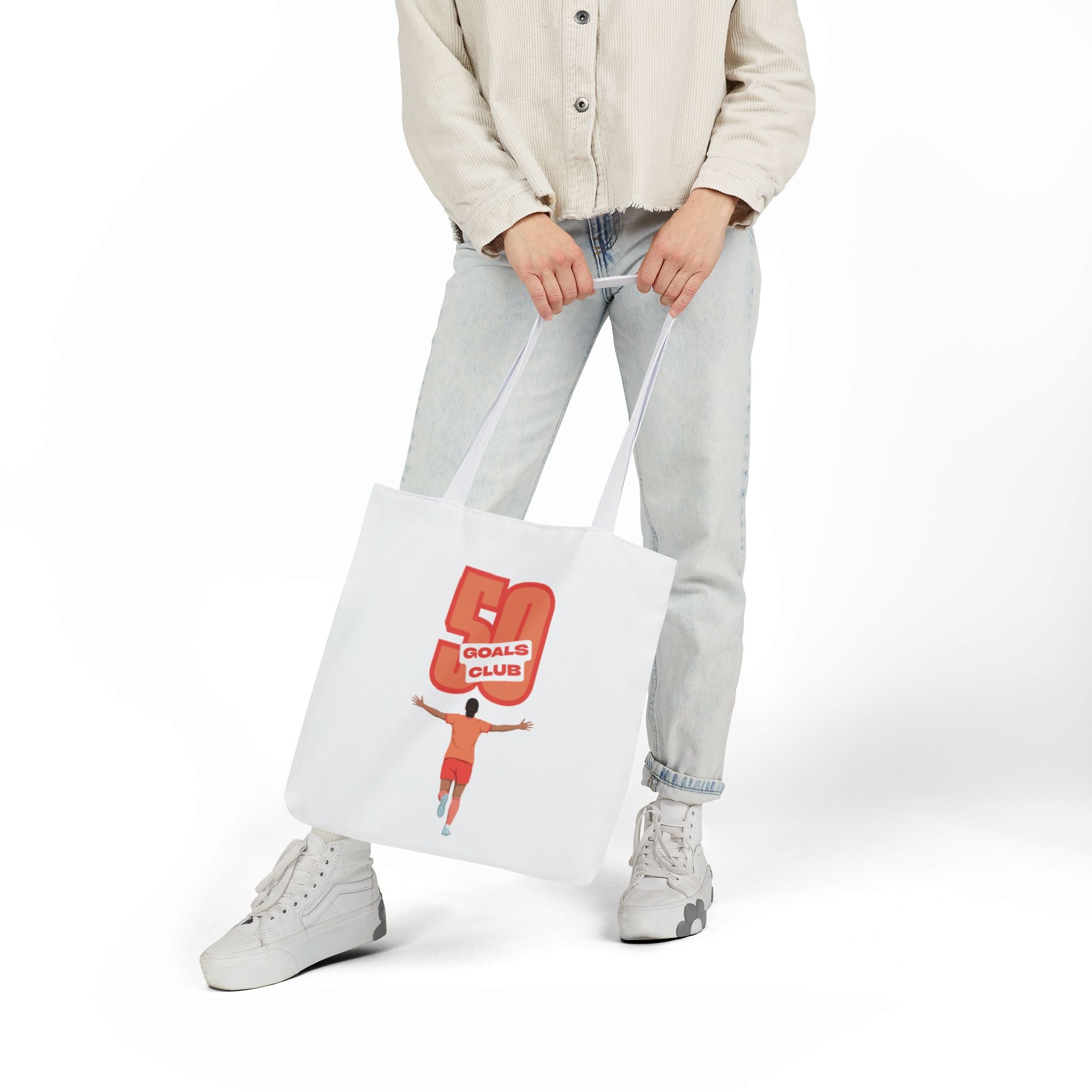 A white canvas tote bag with two shoulder straps, featuring a graphic print of a player running underneath a '50 GOALS CLUB' graphic