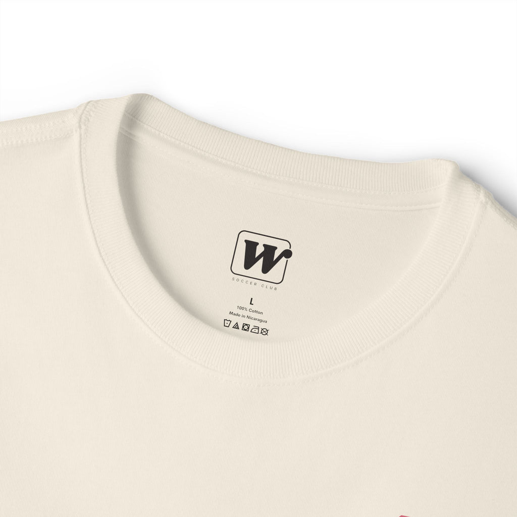 Natural boxy t-shirt close-up showing the inner neck label with a small W Soccer Club logo.