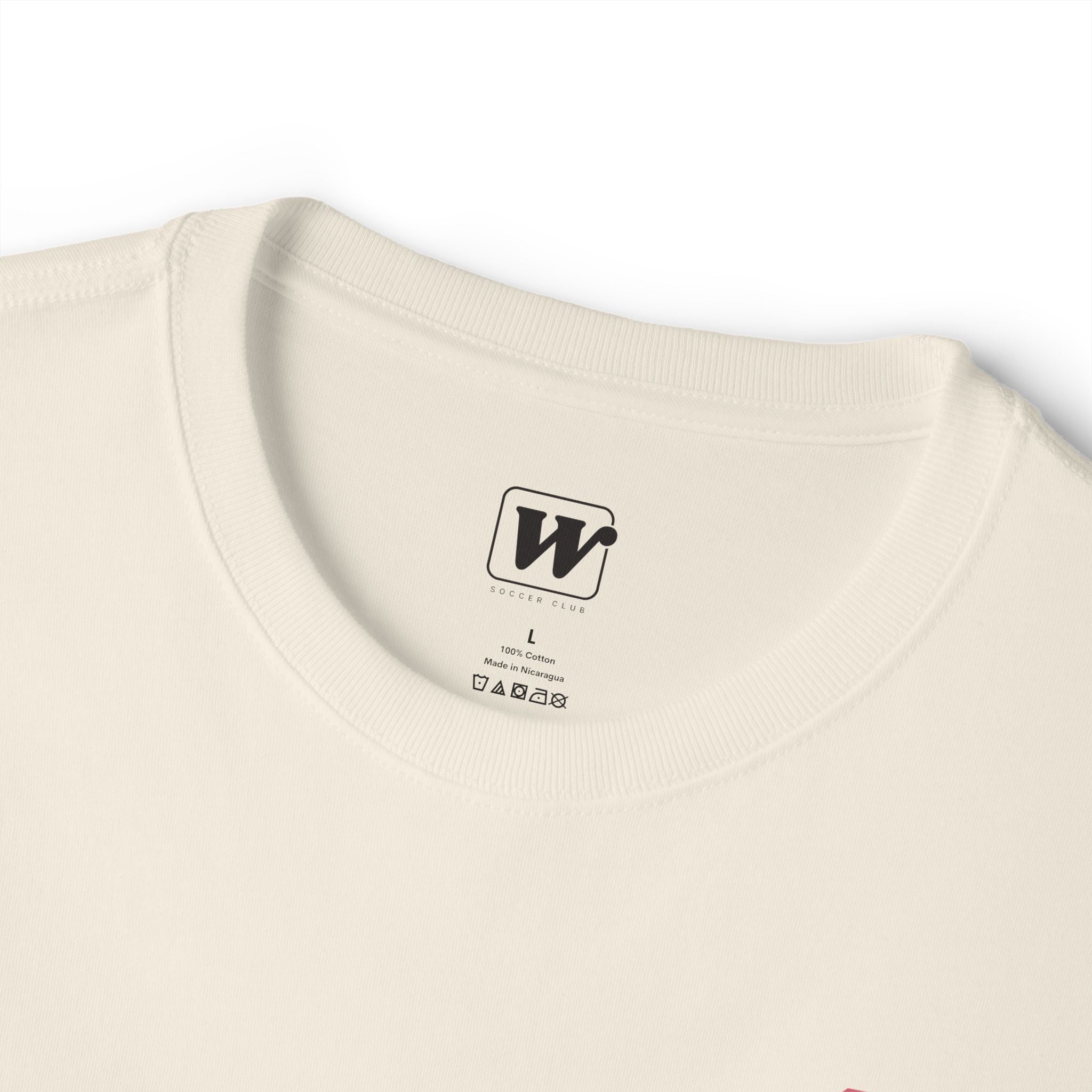 Natural boxy t-shirt close-up showing the inner neck label with a small W Soccer Club logo.