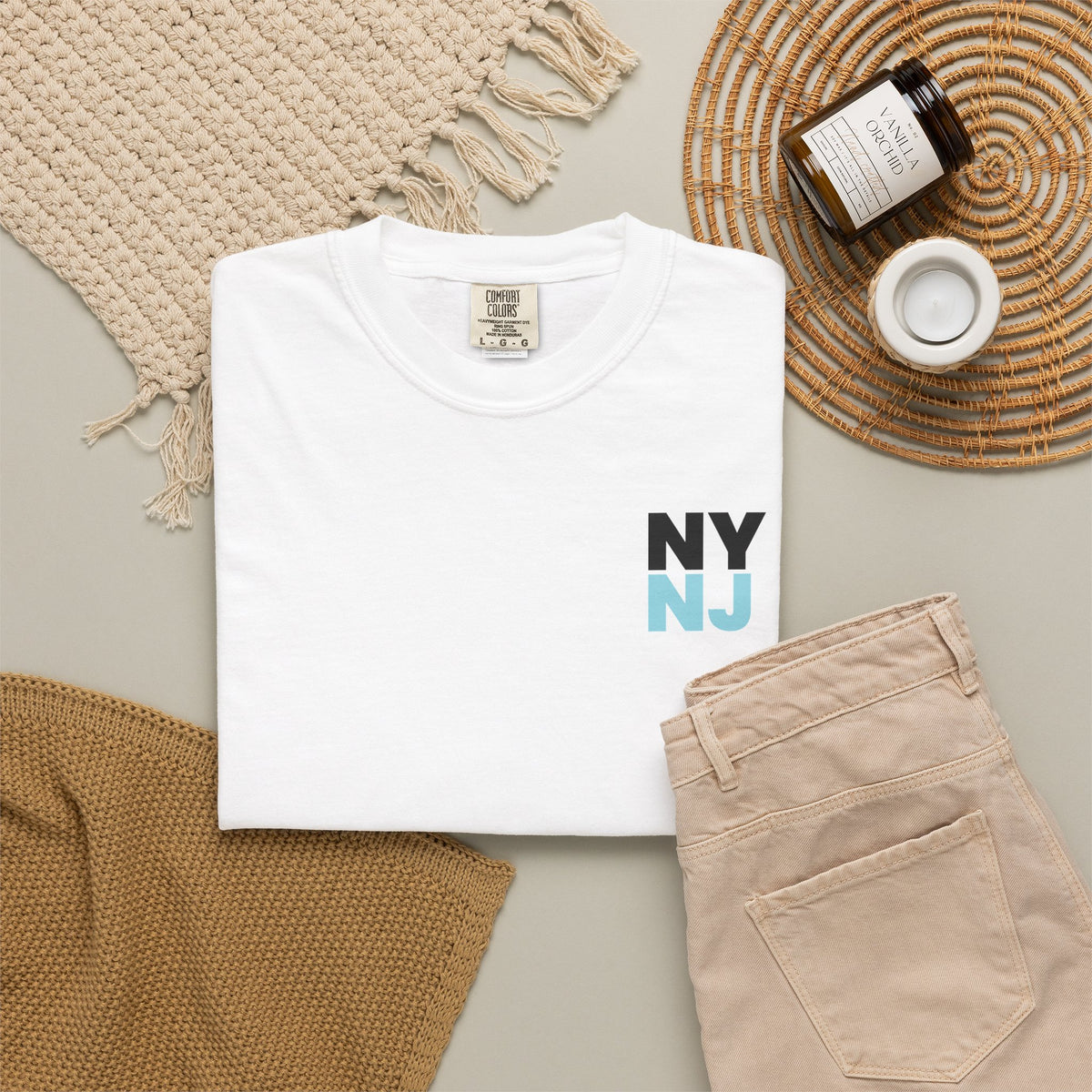White folded T-shirt with 'NY NJ' printed on the chest