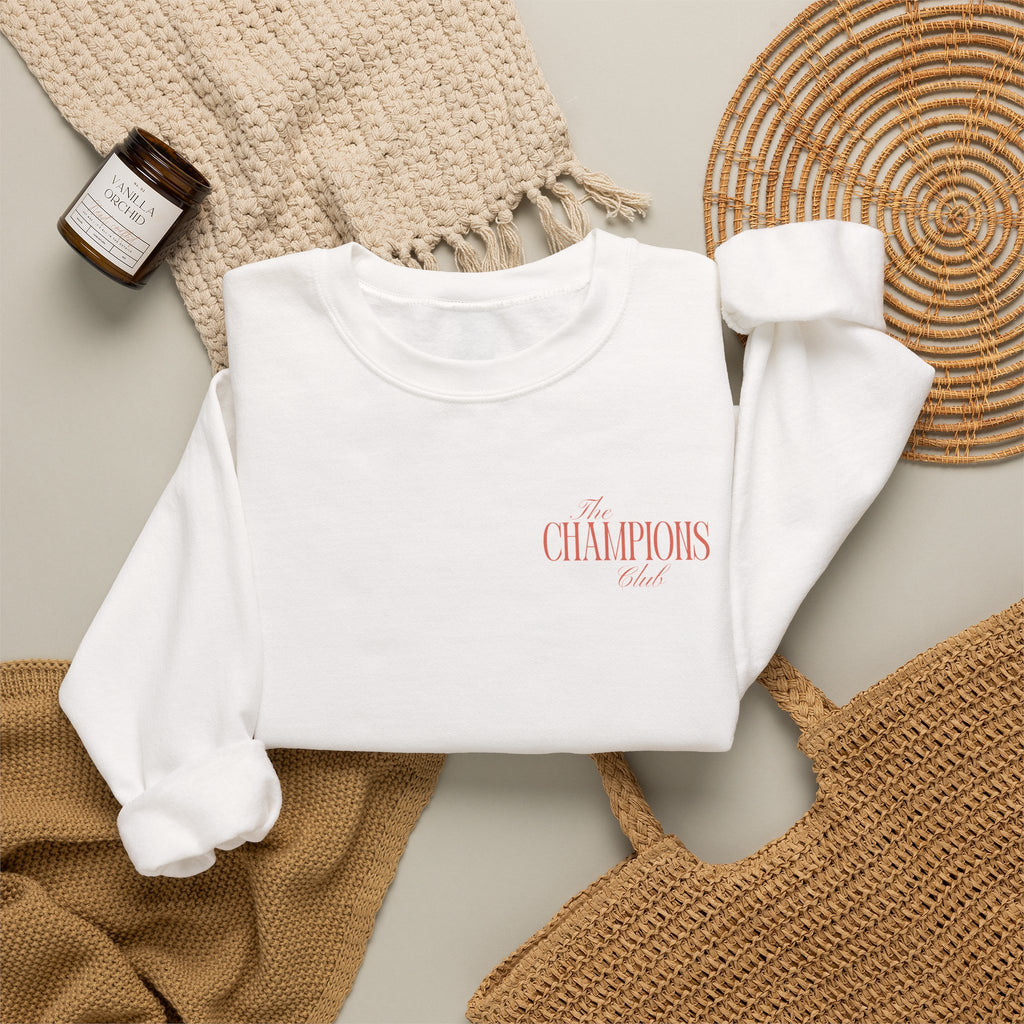 White sweatshirt with The Champions Club pocket logo on the front