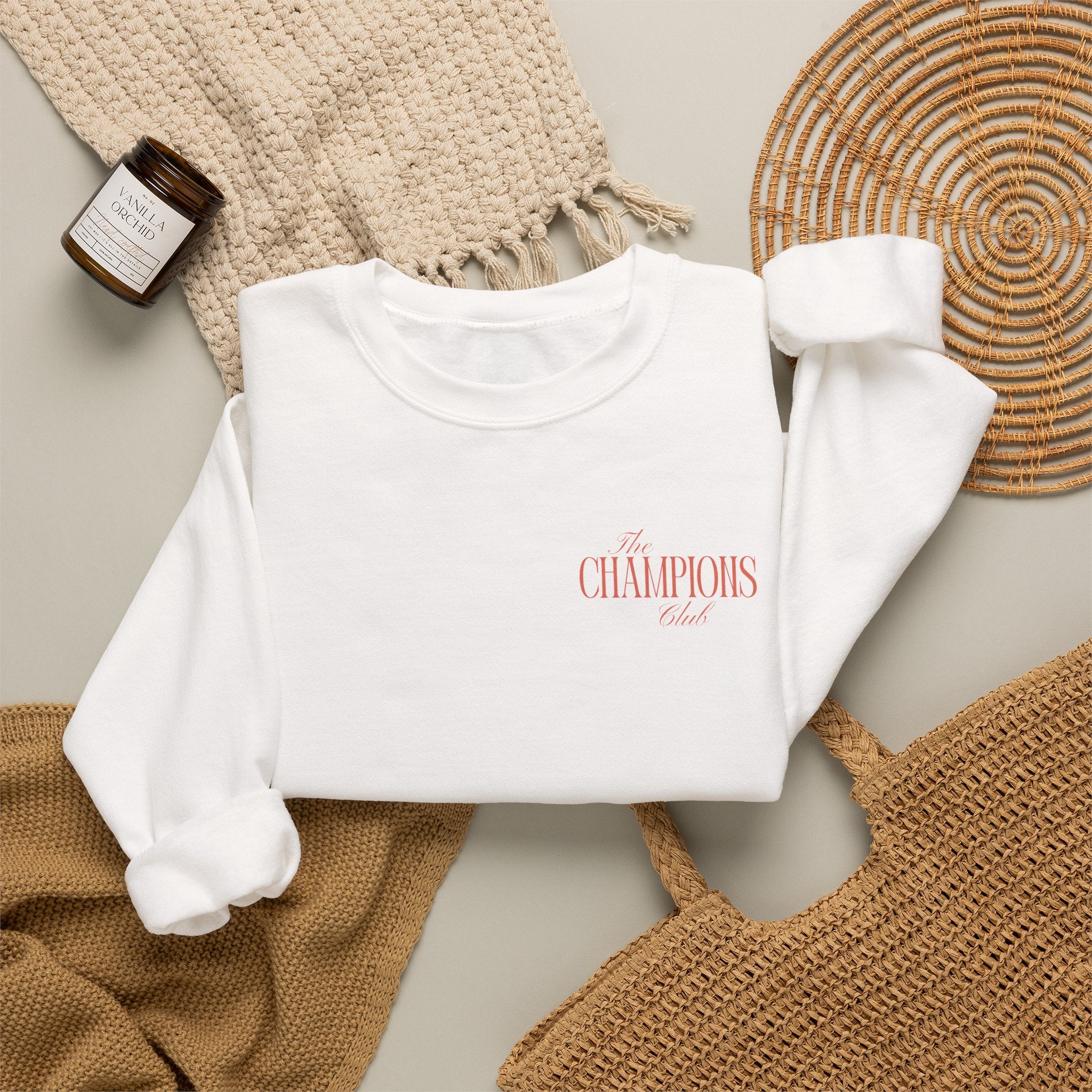 White sweatshirt with The Champions Club pocket logo on the front