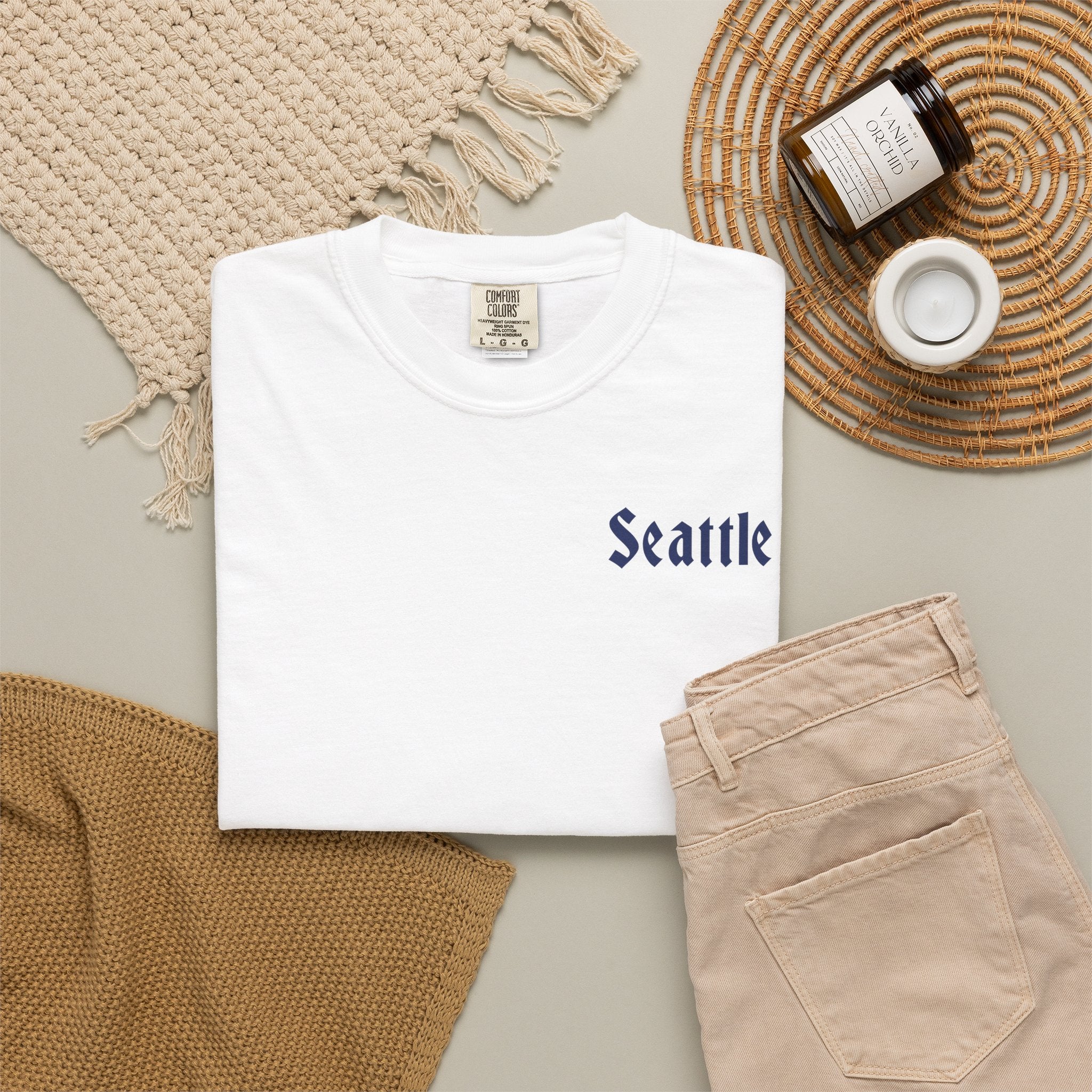 White heavyweight garment-dyed t-shirt front view featuring a minimal "Seattle" script on the left chest.