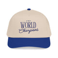 A two-tone baseball cap with an off-white crown and a royal blue brim, featuring '1999 World Champions' embroidered in blue on the front.