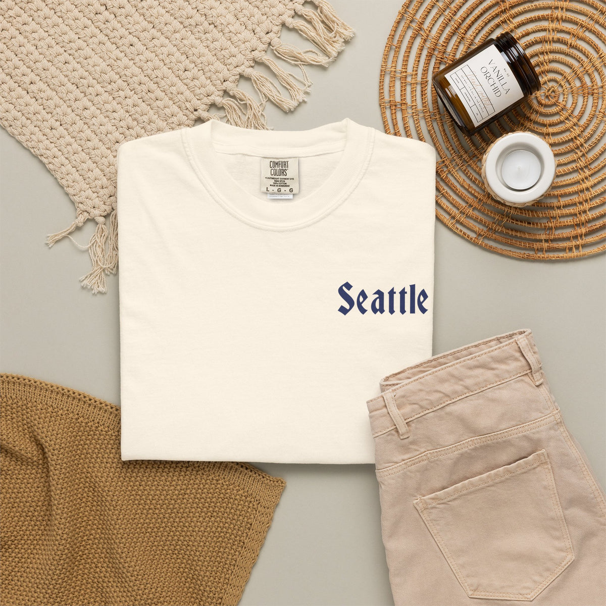 Ivory heavyweight garment-dyed t-shirt front view featuring a minimal "Seattle" script on the left chest.