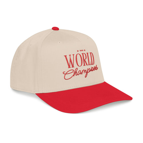 A beige and red baseball cap with '1999 World Champions' embroidered in red on the front, set against a plain white background.
