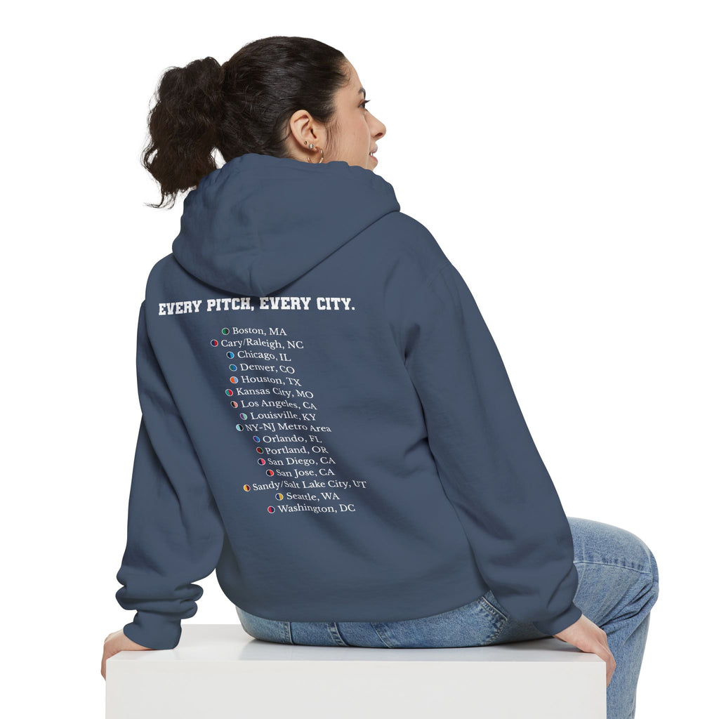 Denim colored hoodie with chest logo on the front and list of cities on the back