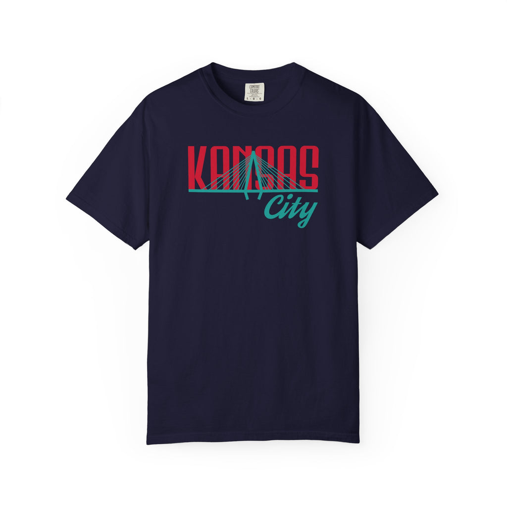 Navy garment-dyed t-shirt front view featuring "Kansas City" with bridge graphic in red and teal retro script across the chest.