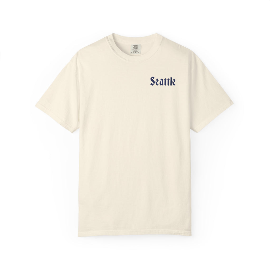 Ivory heavyweight garment-dyed t-shirt front view featuring a minimal "Seattle" script on the left chest.