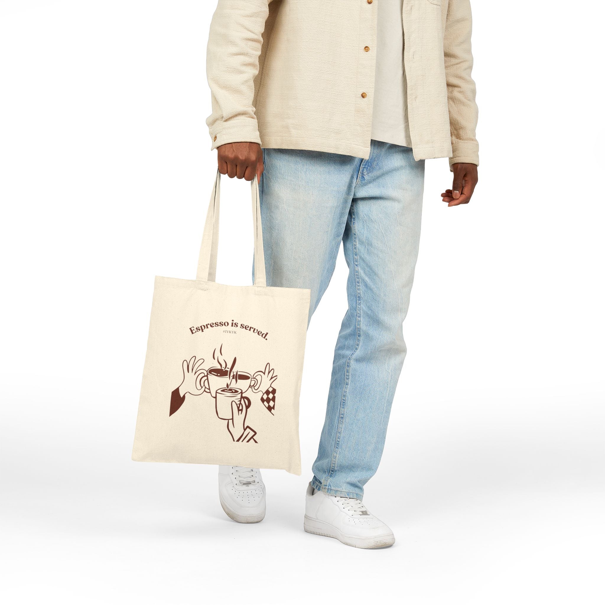 Canvas tote bag featuring an Espresso is served graphic with three clinking coffee mugs on the back and a front pocket W logo from The W-League collection
