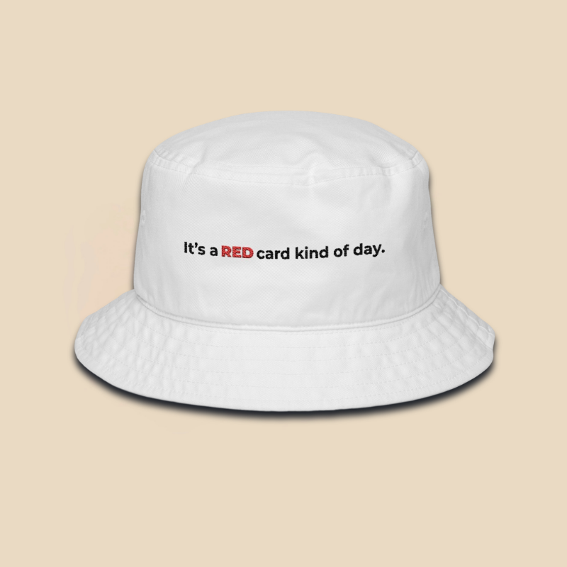 White embroidered soccer fan bucket hat featuring the text It's a red card kind of day in high-contrast typography